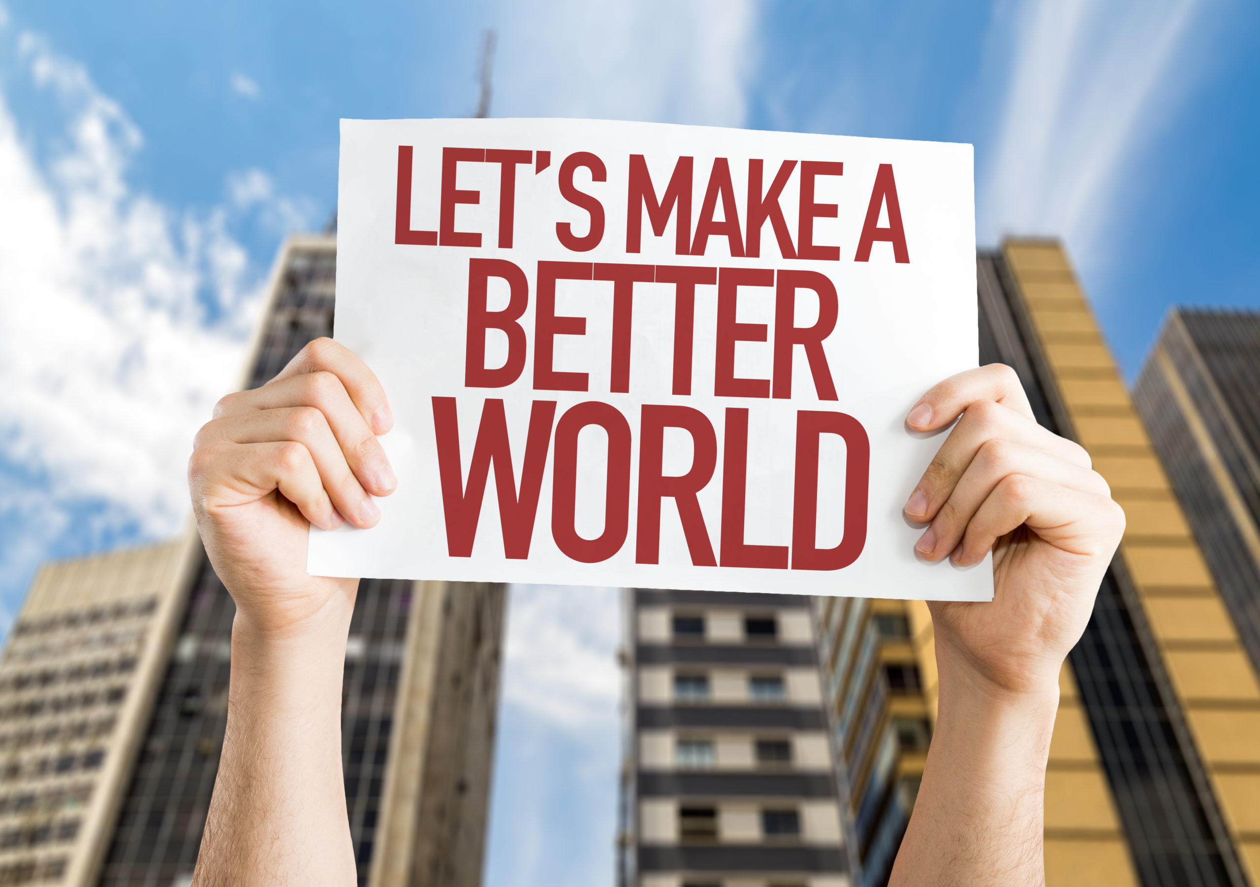 Photo: hands holding a sign that says Lets Make a Better World